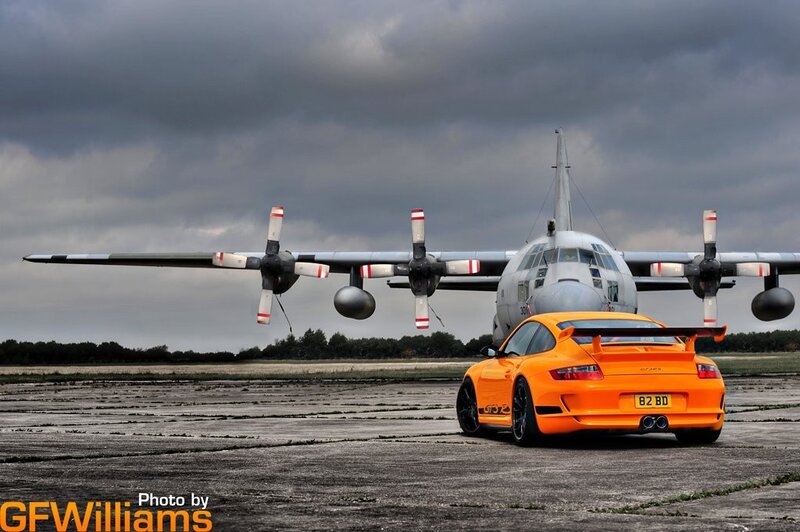 Orange car and military plane