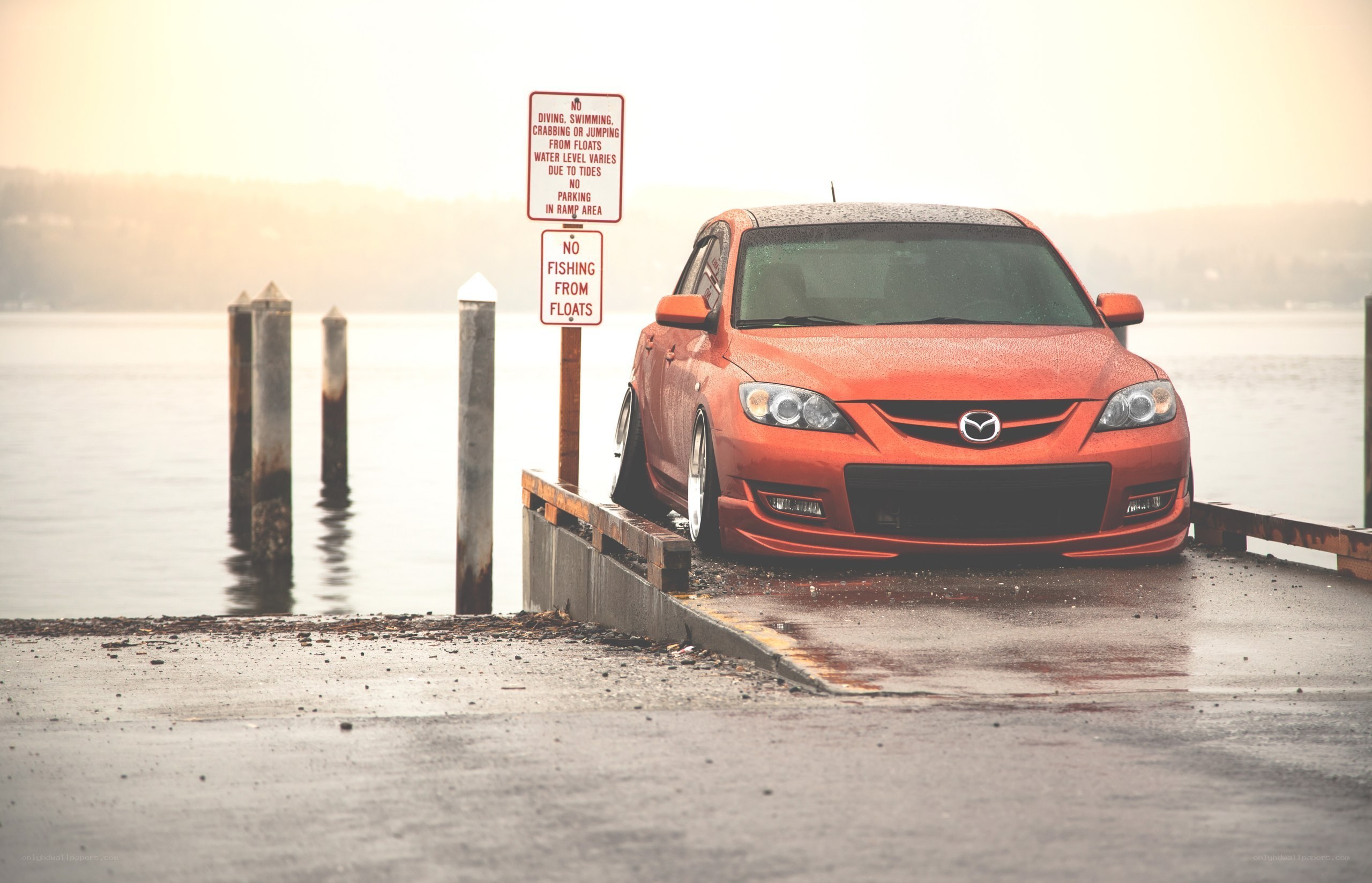 Orange car at a dock