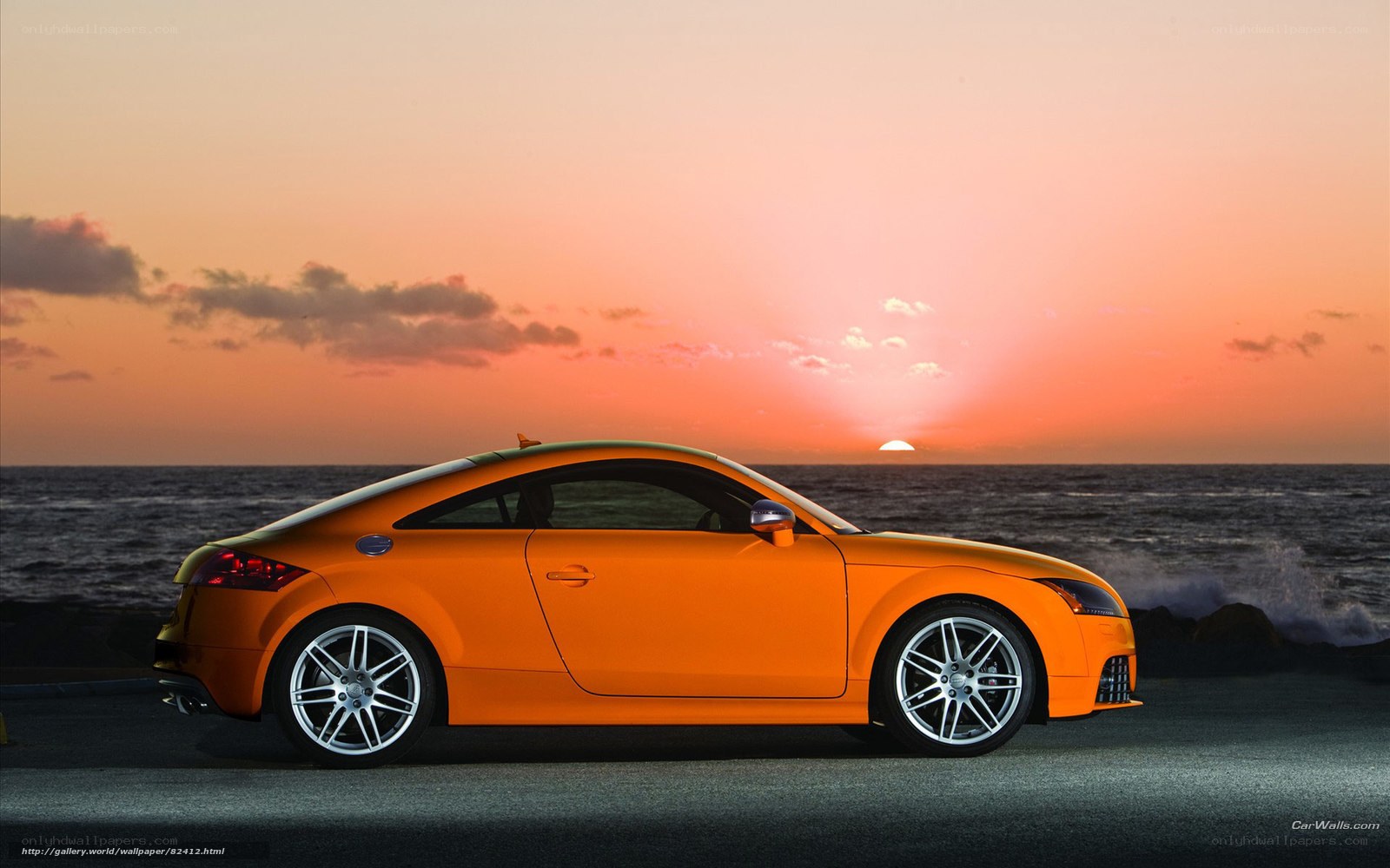 Orange car at sunset by the sea