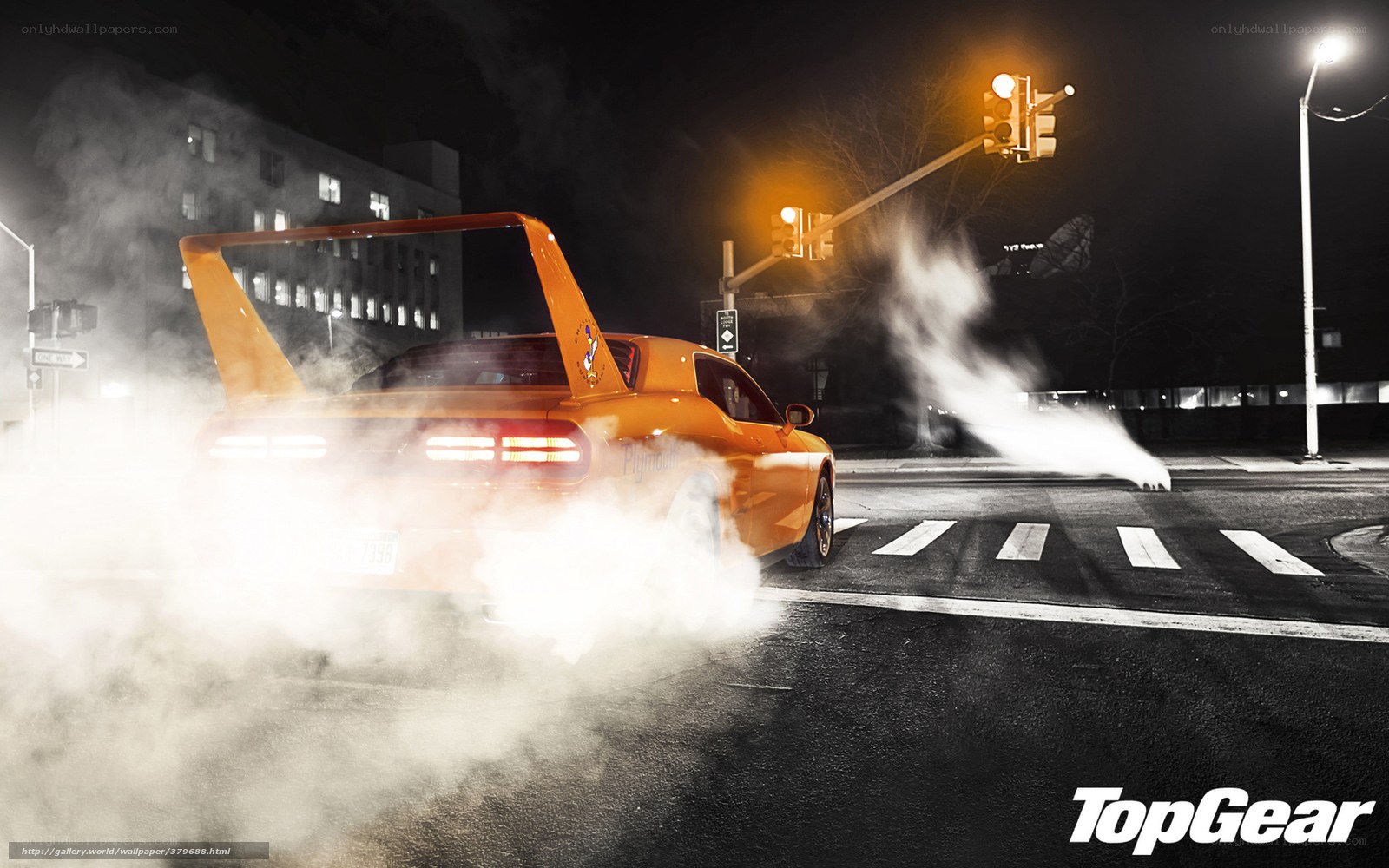 Orange car doing burnout at night