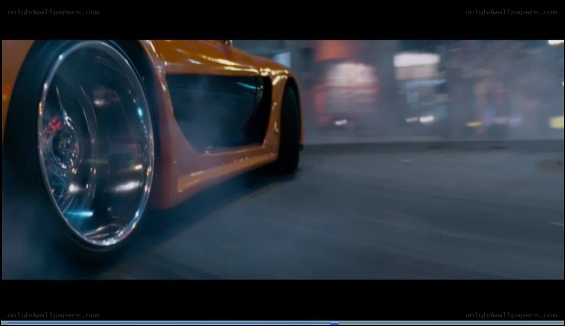 orange car drifting at night