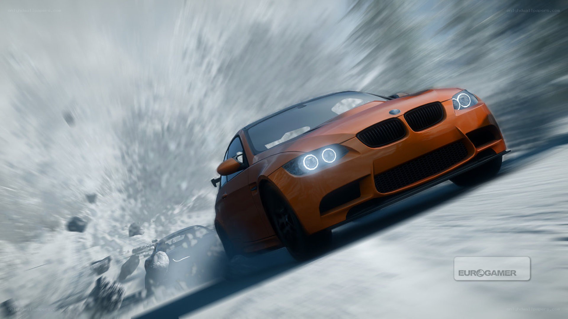 orange car drifting in snow