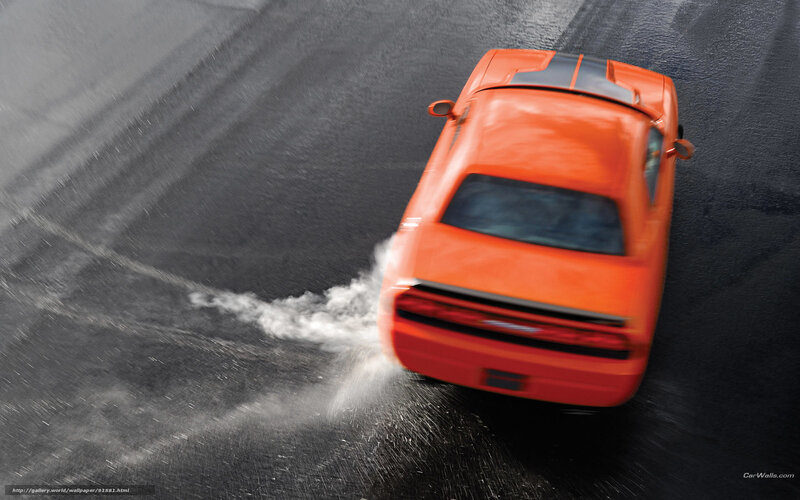 Orange car drifting on wet road