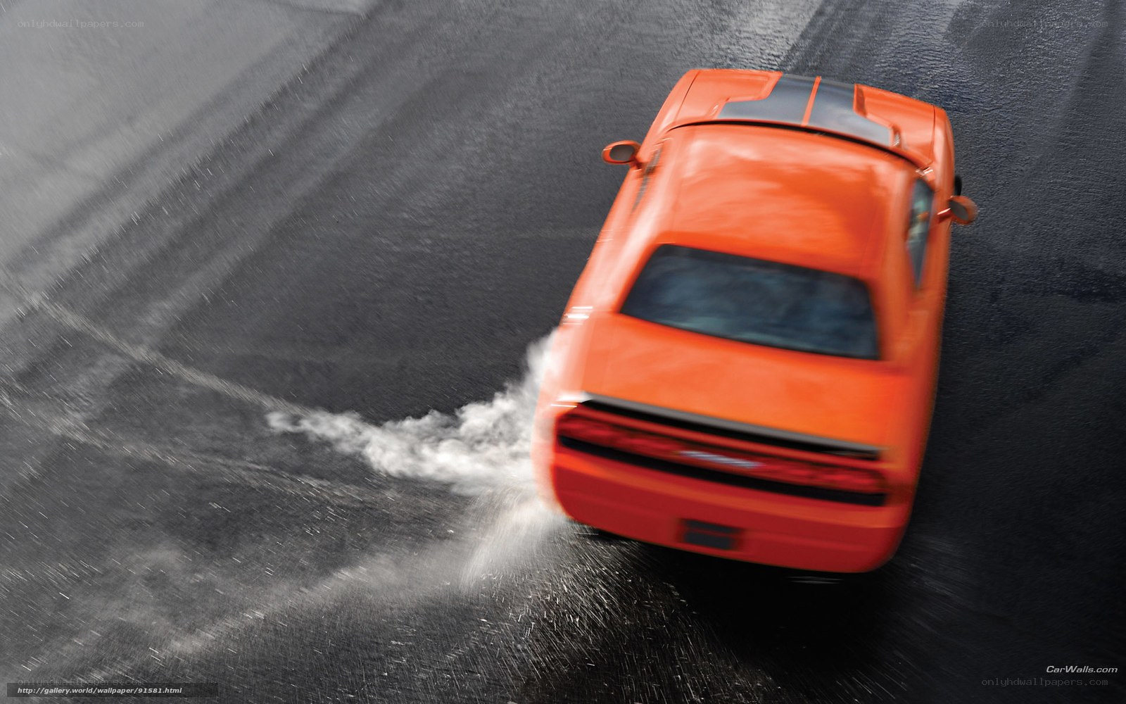 Orange car drifting on wet road