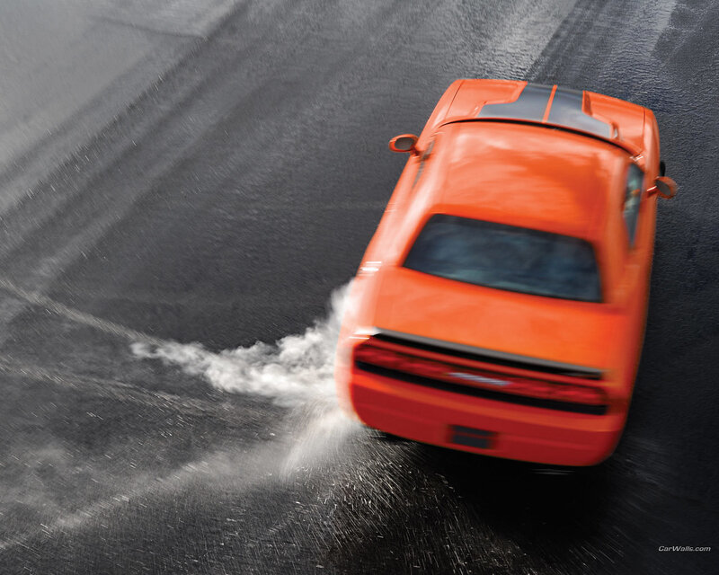 Orange car drifting on wet track