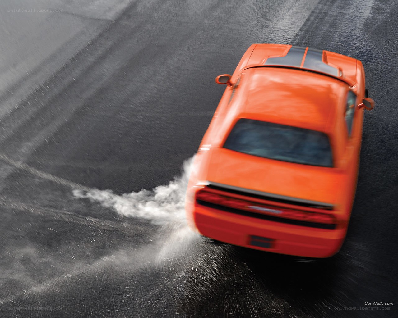 Orange car drifting on wet track