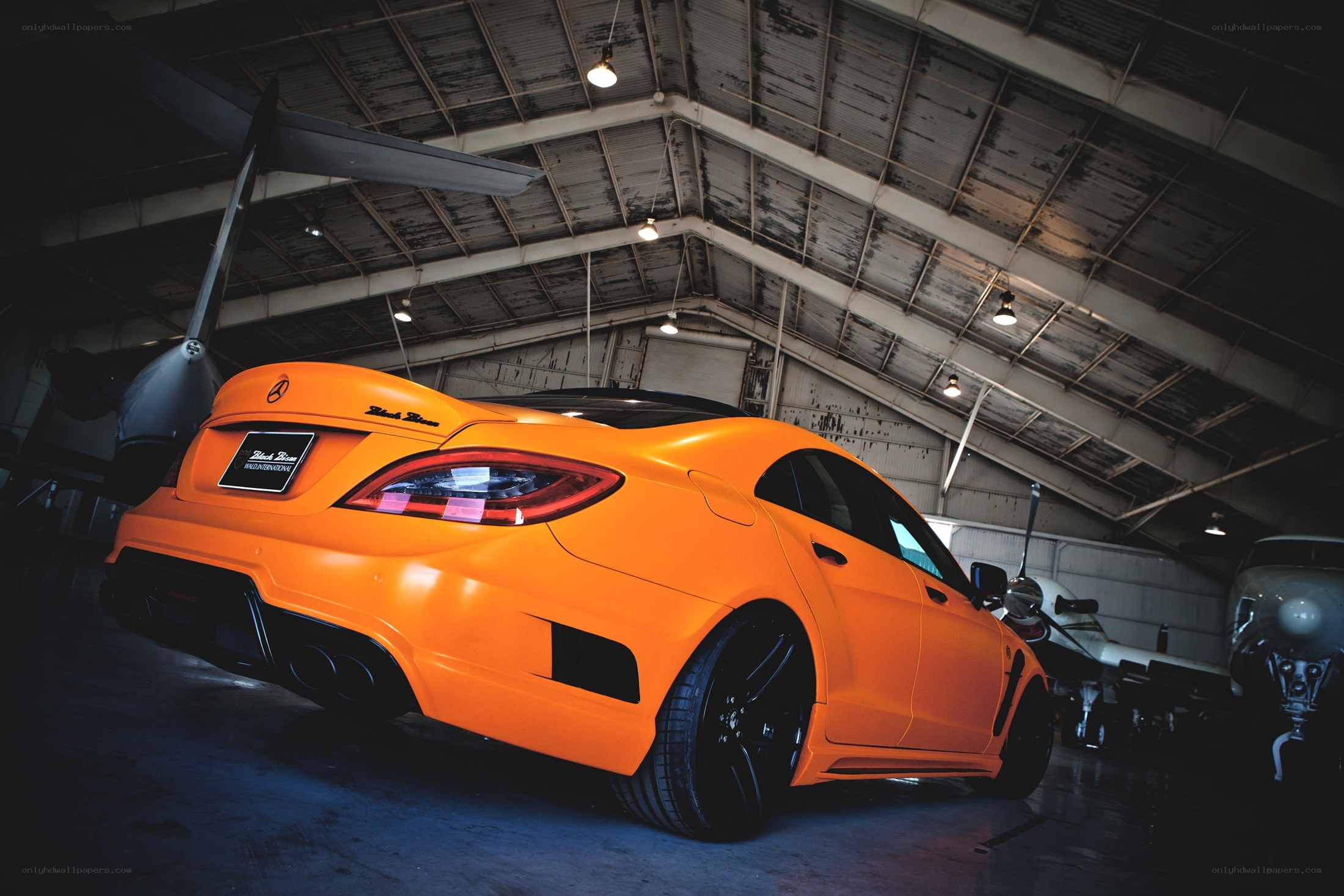 Orange car in a hangar