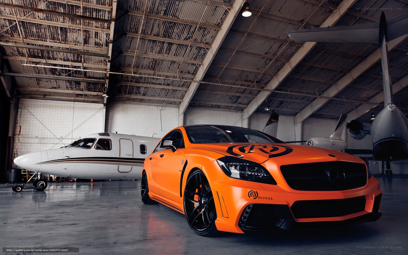 Orange car in airplane hangar