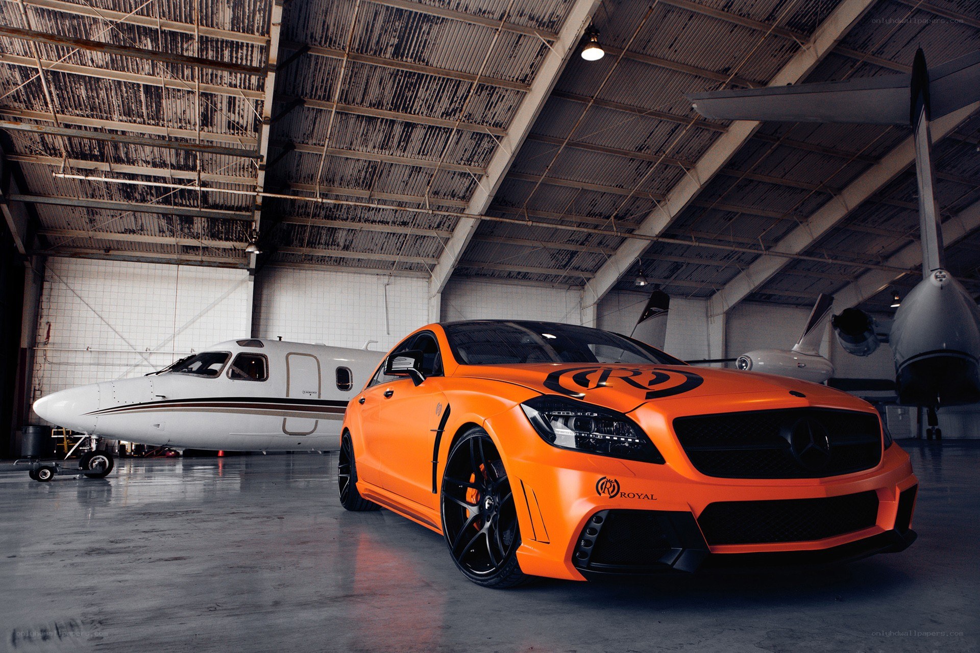 Orange car in airplane hangar