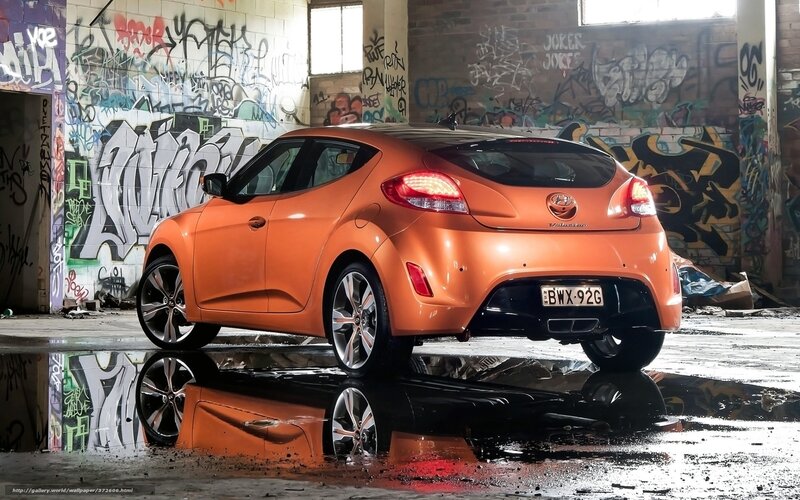 orange car in graffiti alley