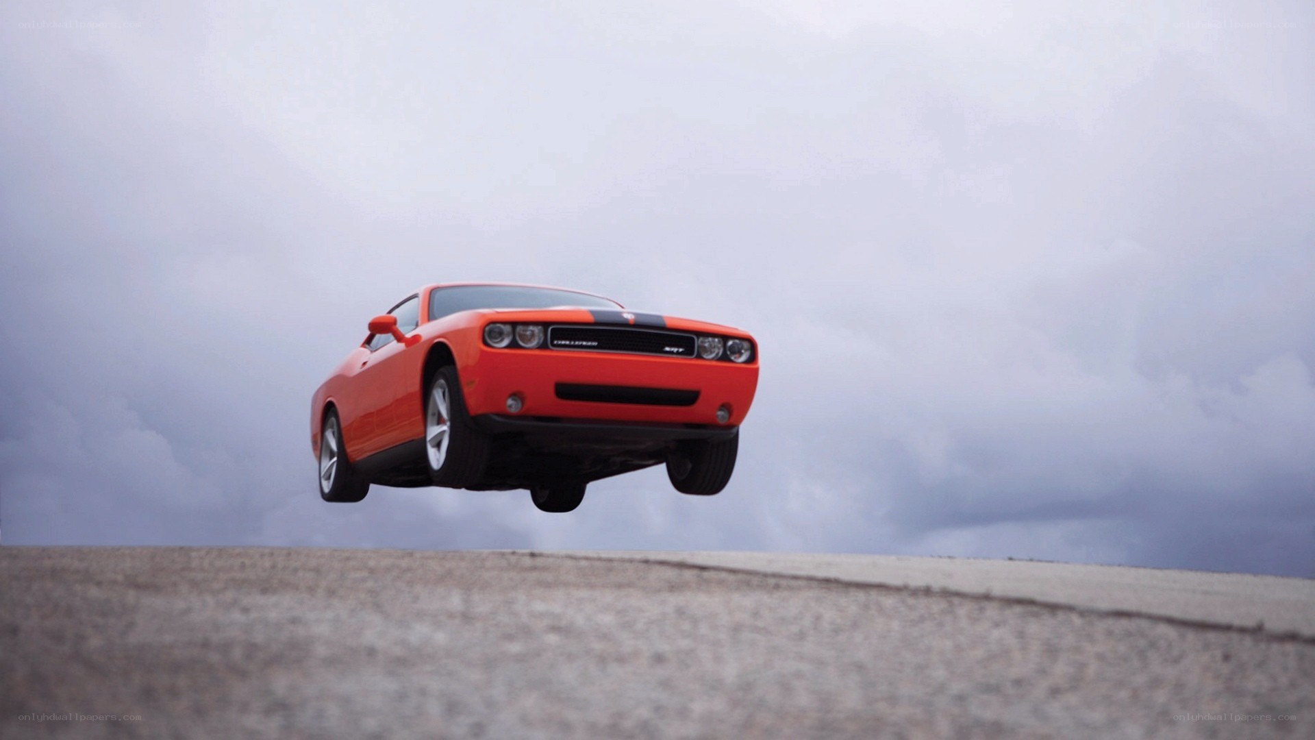 Orange car in mid-air jump