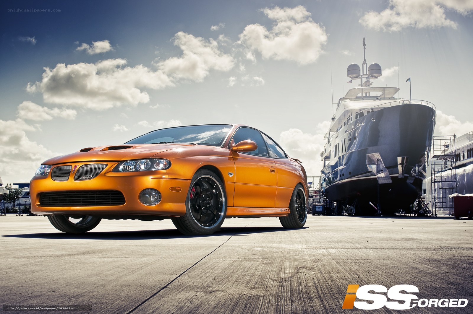 Orange car near yacht