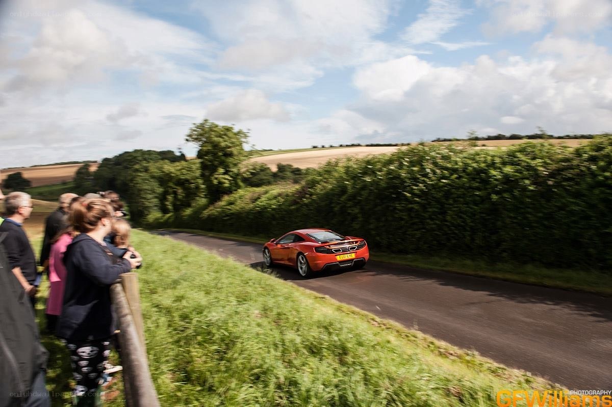 Orange car on country road