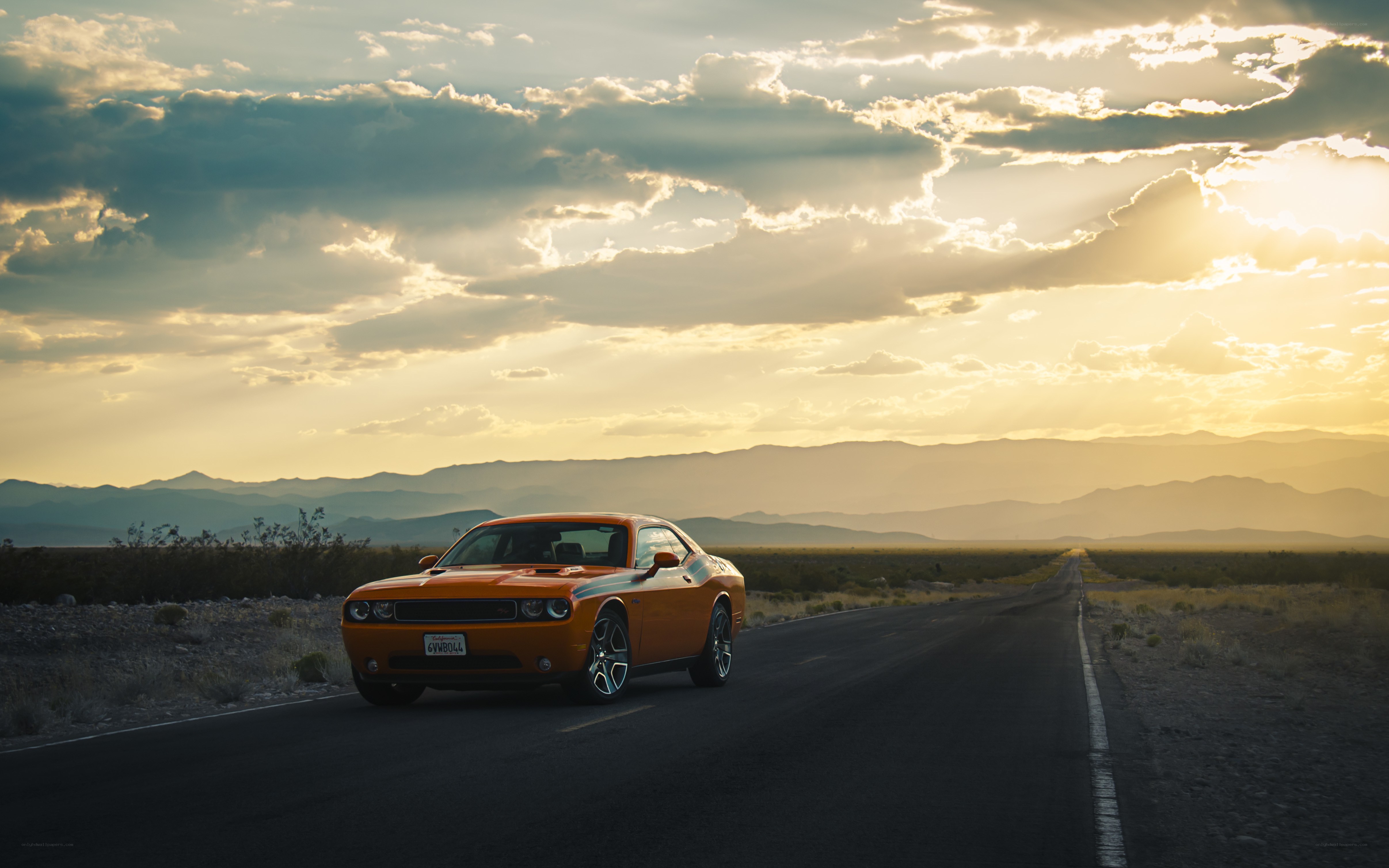 Orange car on desert road