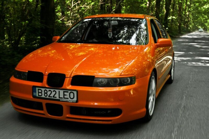 orange car on forest road