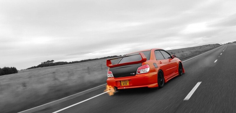 orange car on road with flames