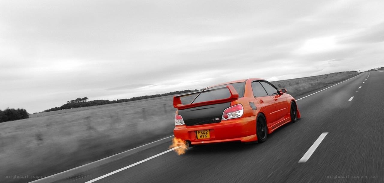 orange car on road with flames