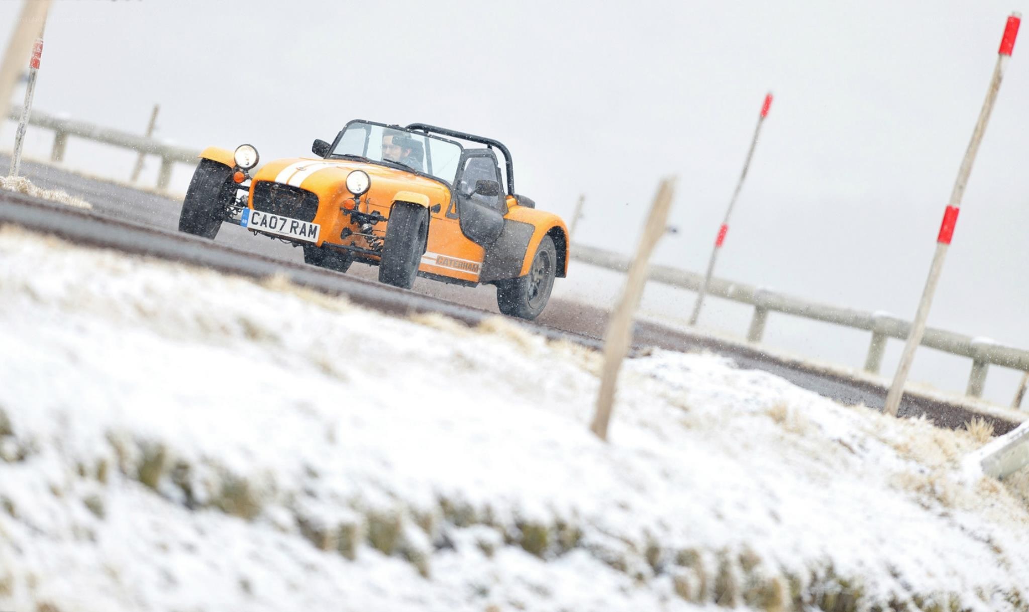 Orange car on snowy road