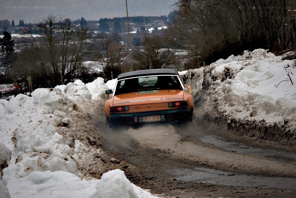 Orange car on snowy road