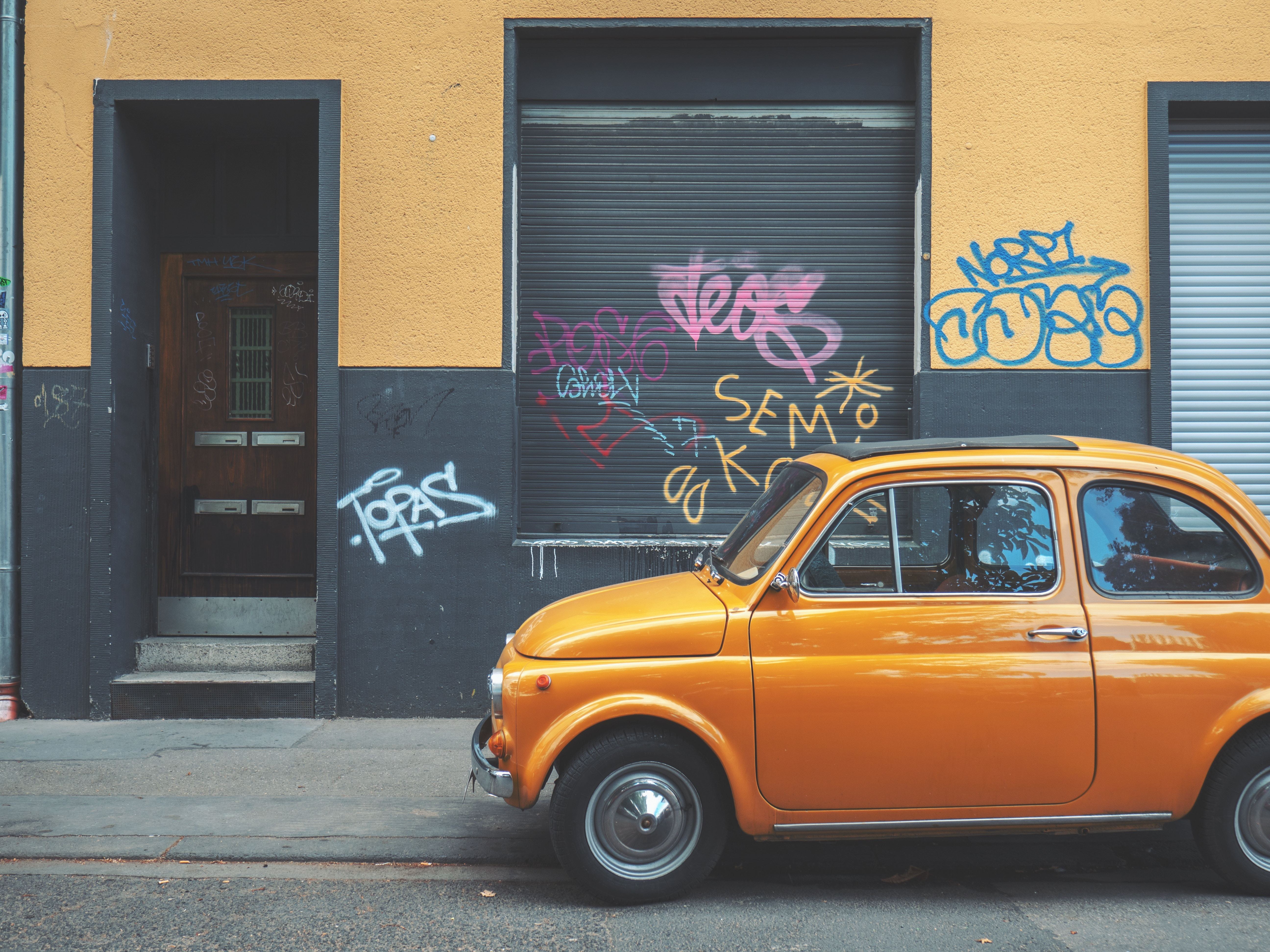 Orange car parked on street