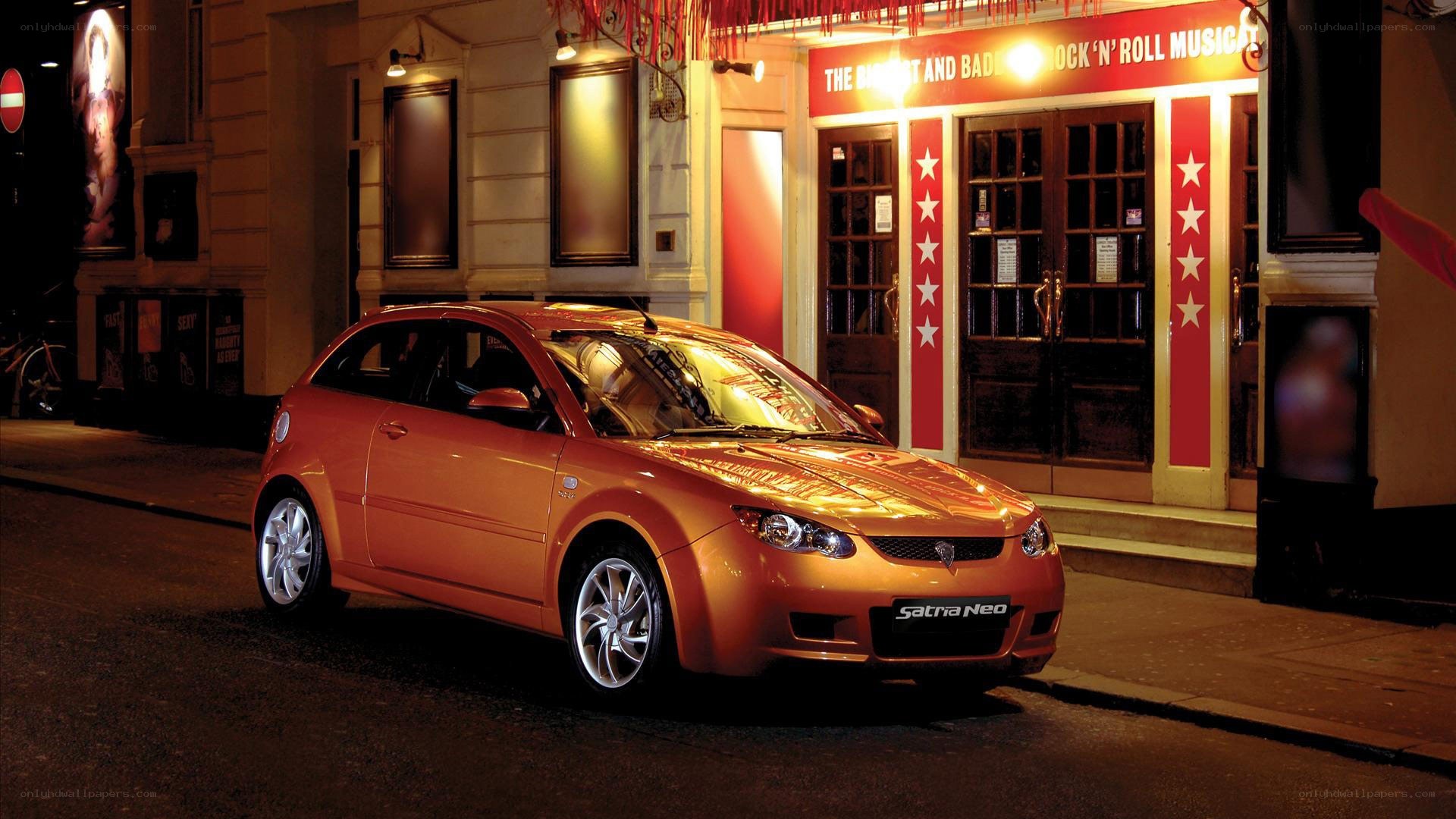 Orange car parked outside theater