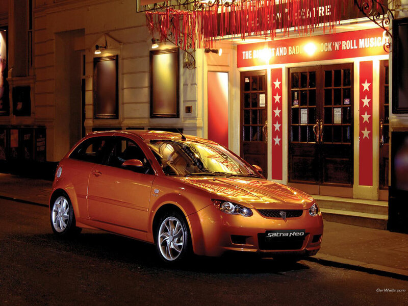 Orange car parked outside theatre