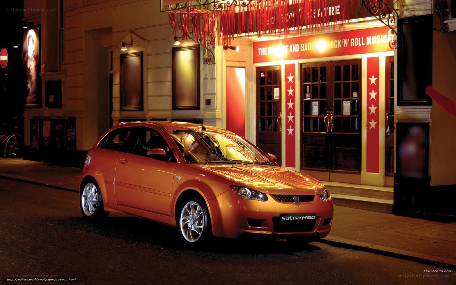 Orange car parked outside theatre