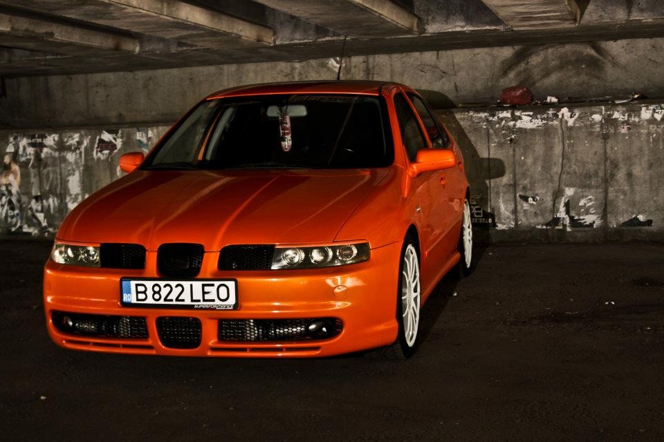 Orange car under a bridge