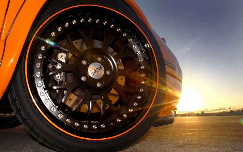 orange car wheel at sunset