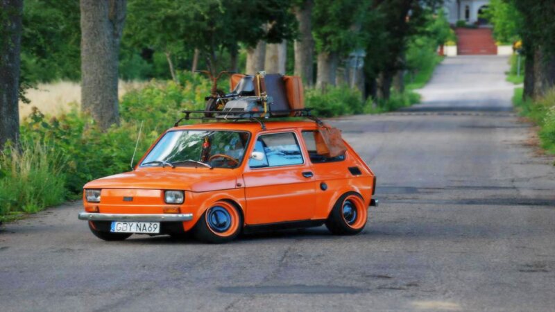 Orange car with luggage on roof