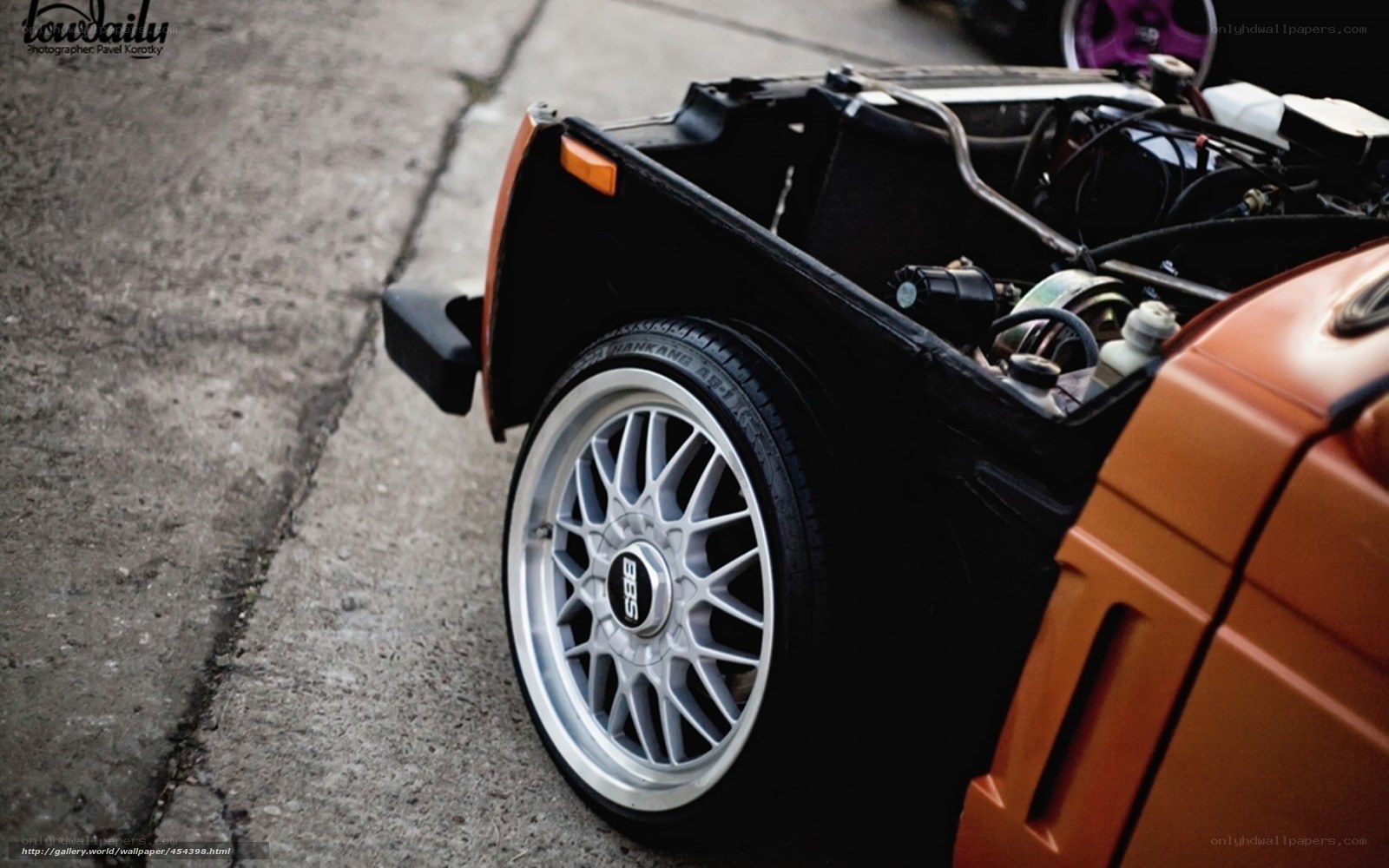 orange car with open engine bay