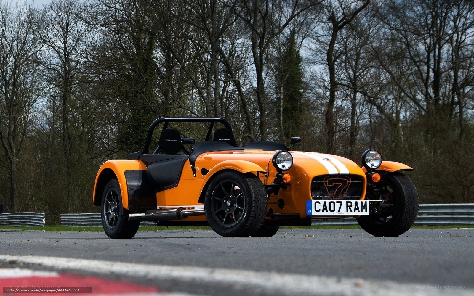 Orange Caterham Seven on a racetrack