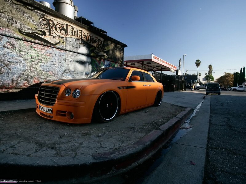 Orange Chrysler on a city street