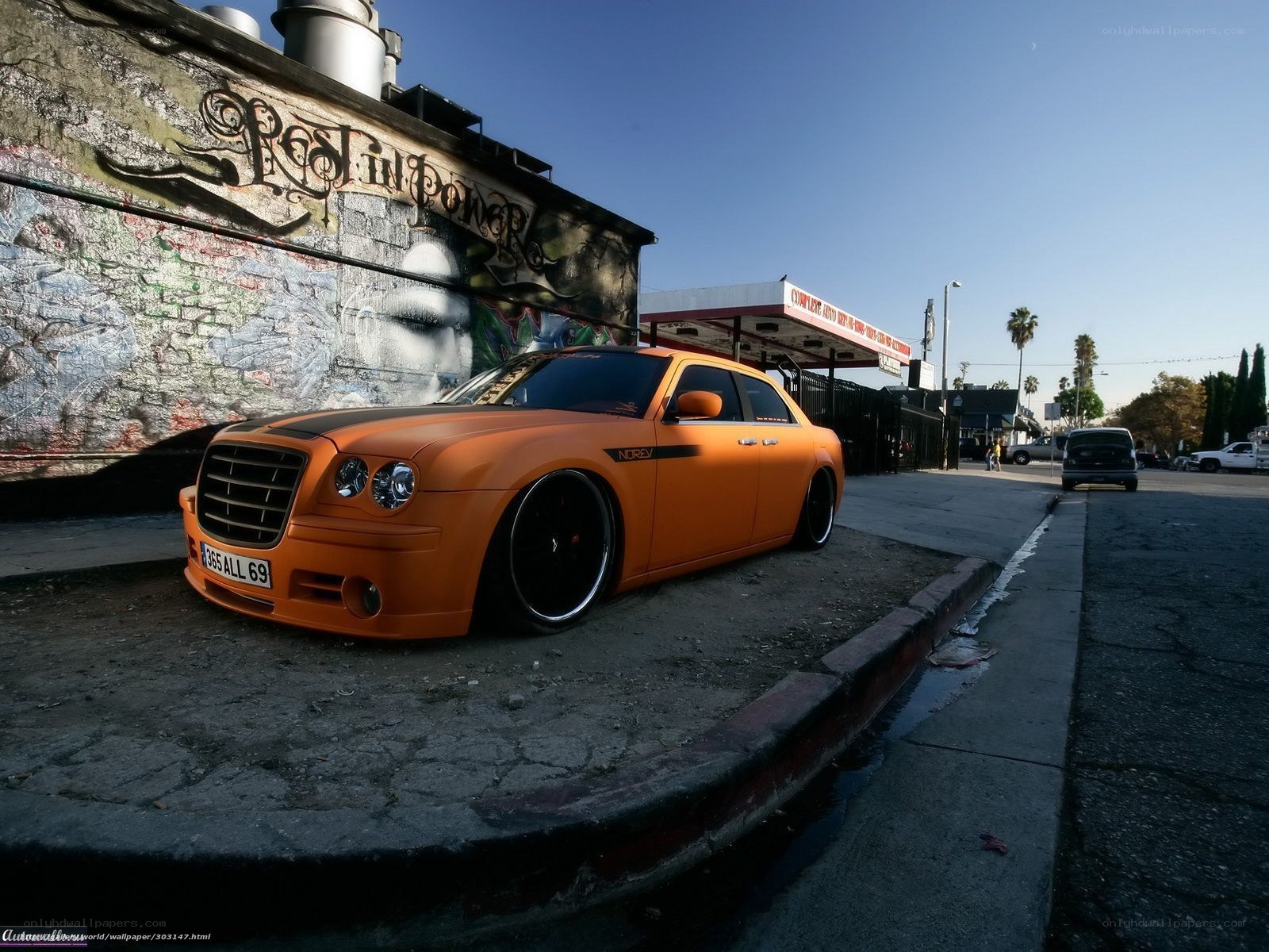Orange Chrysler on a city street
