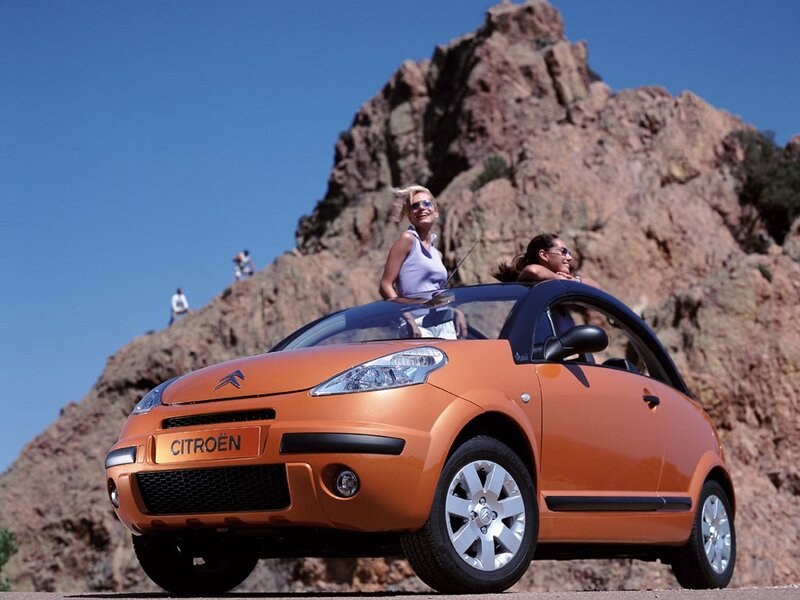 Orange Citroën car on a mountain road