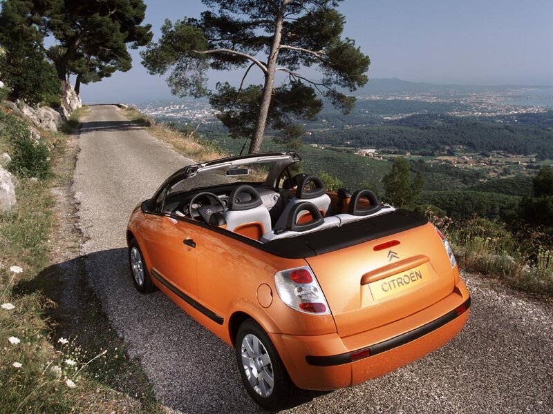 Orange Citroën convertible on a scenic road