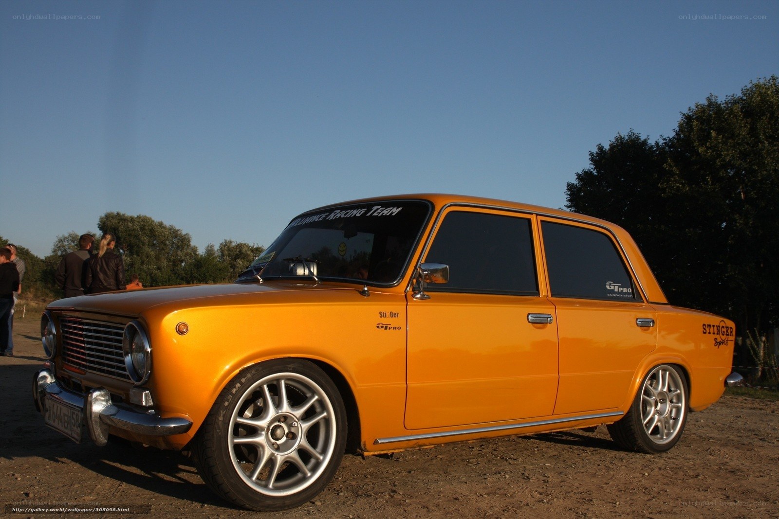 Orange classic car at outdoor event