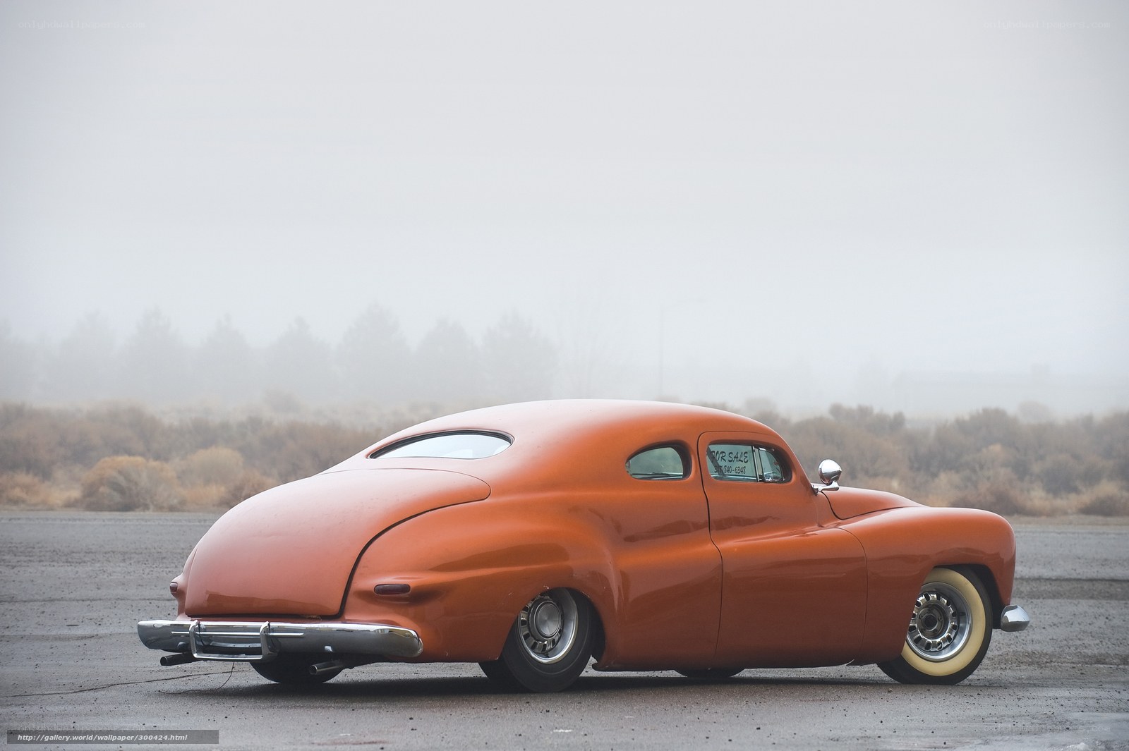 orange classic car in fog