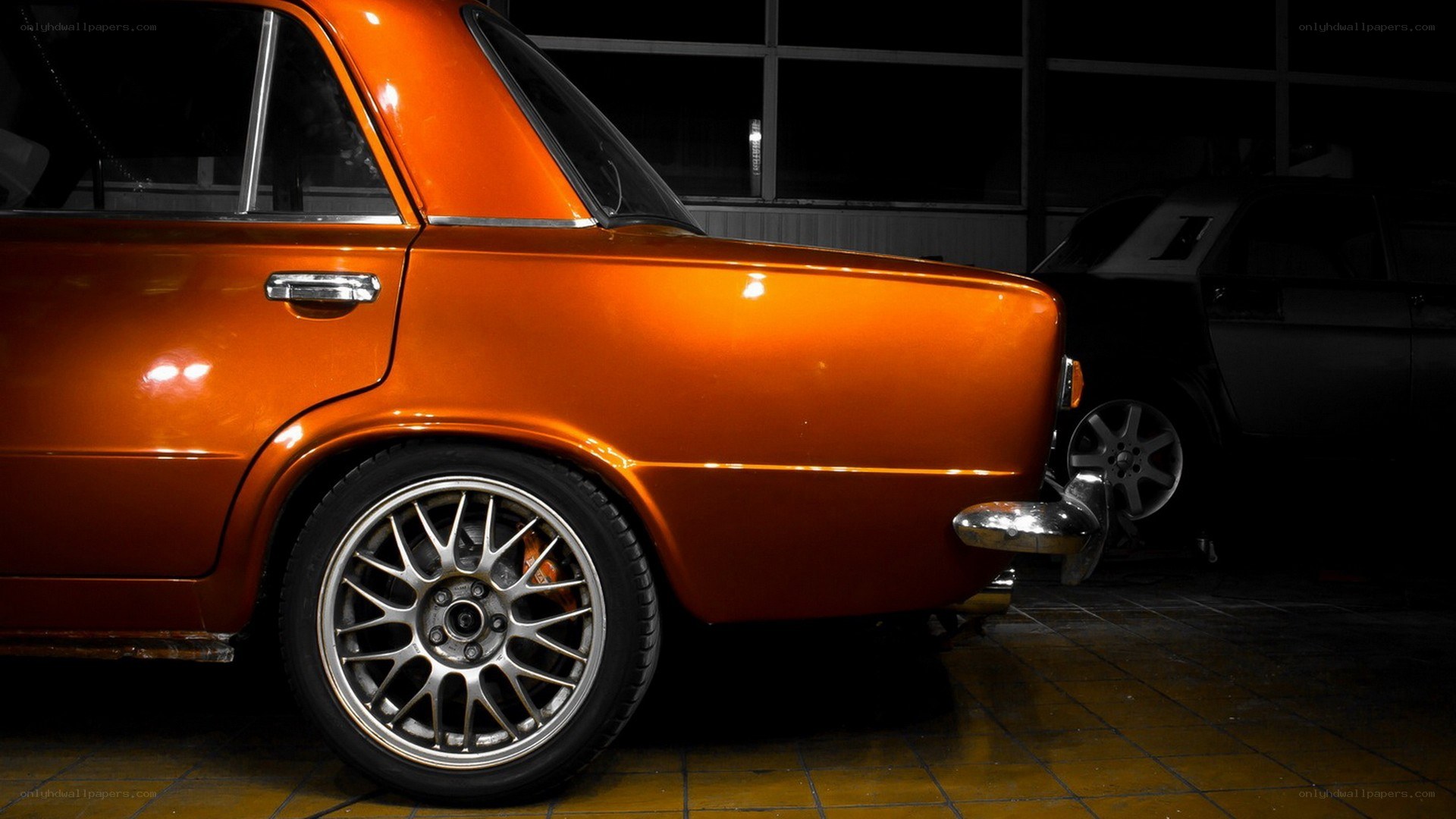 orange classic car in garage