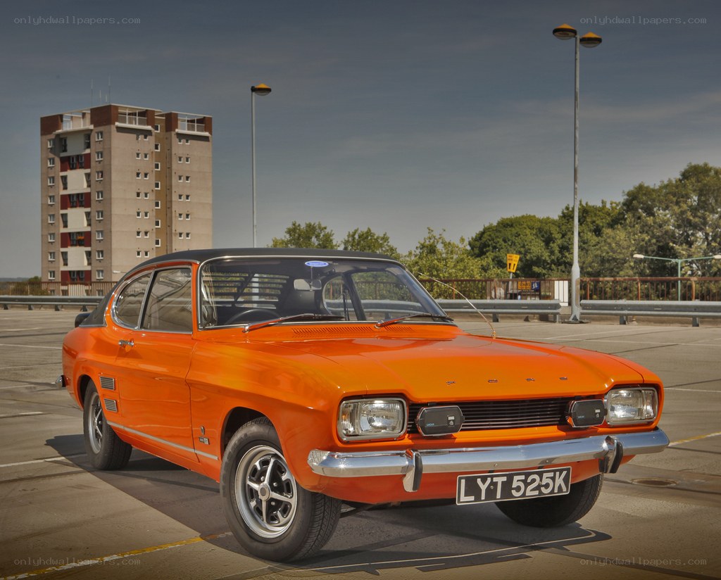 Orange classic car on a bridge