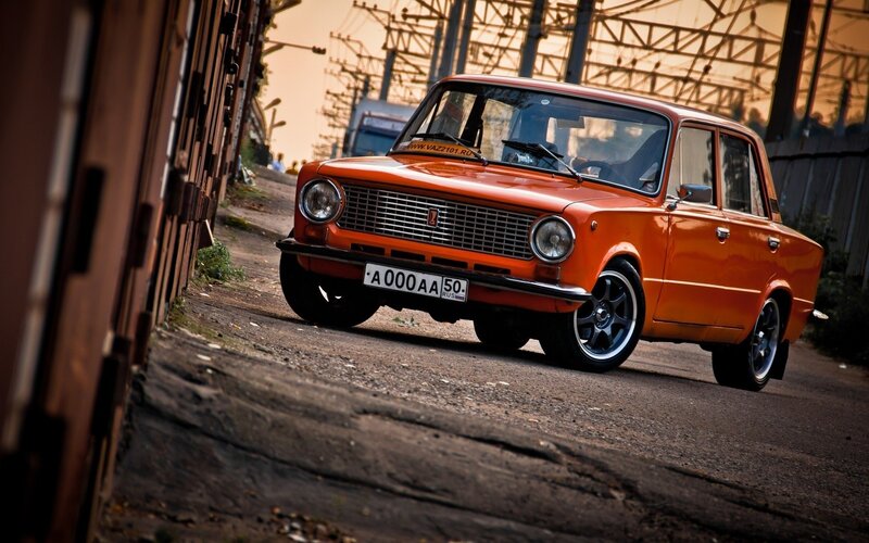 Orange classic car on a street