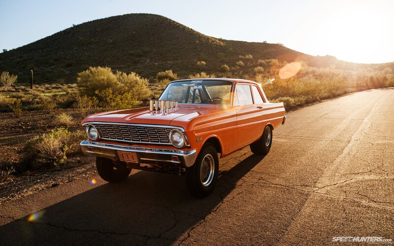 Orange classic car on desert road