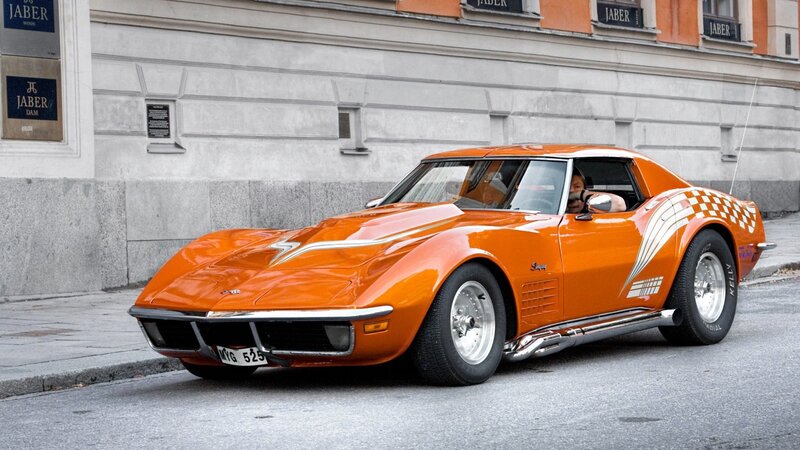 Orange classic Corvette on city street