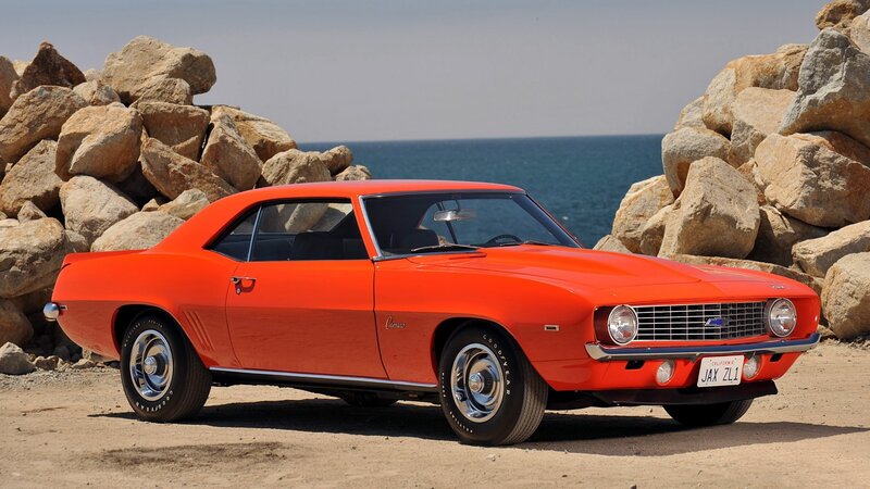 Orange classic muscle car by the sea