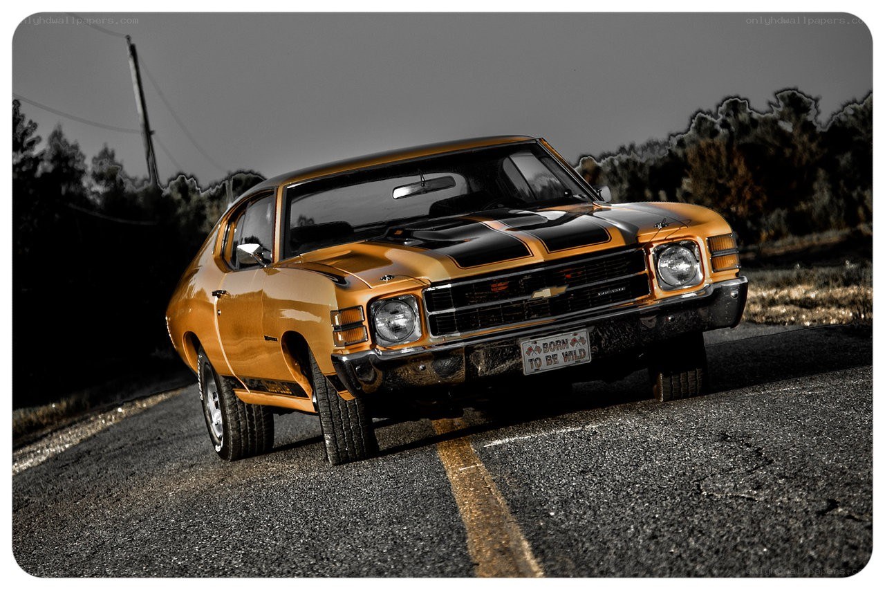 Orange classic muscle car on road