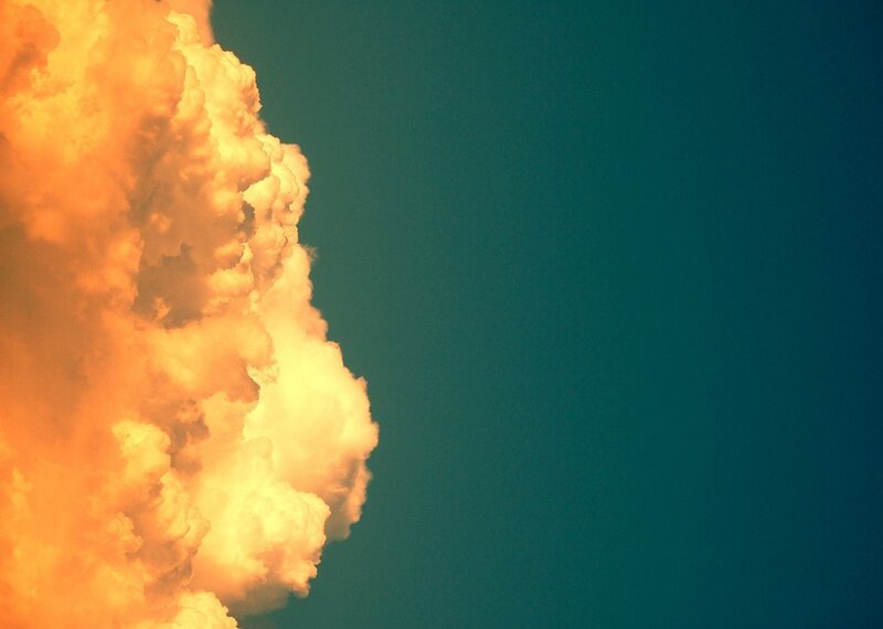 Orange cloud against blue sky