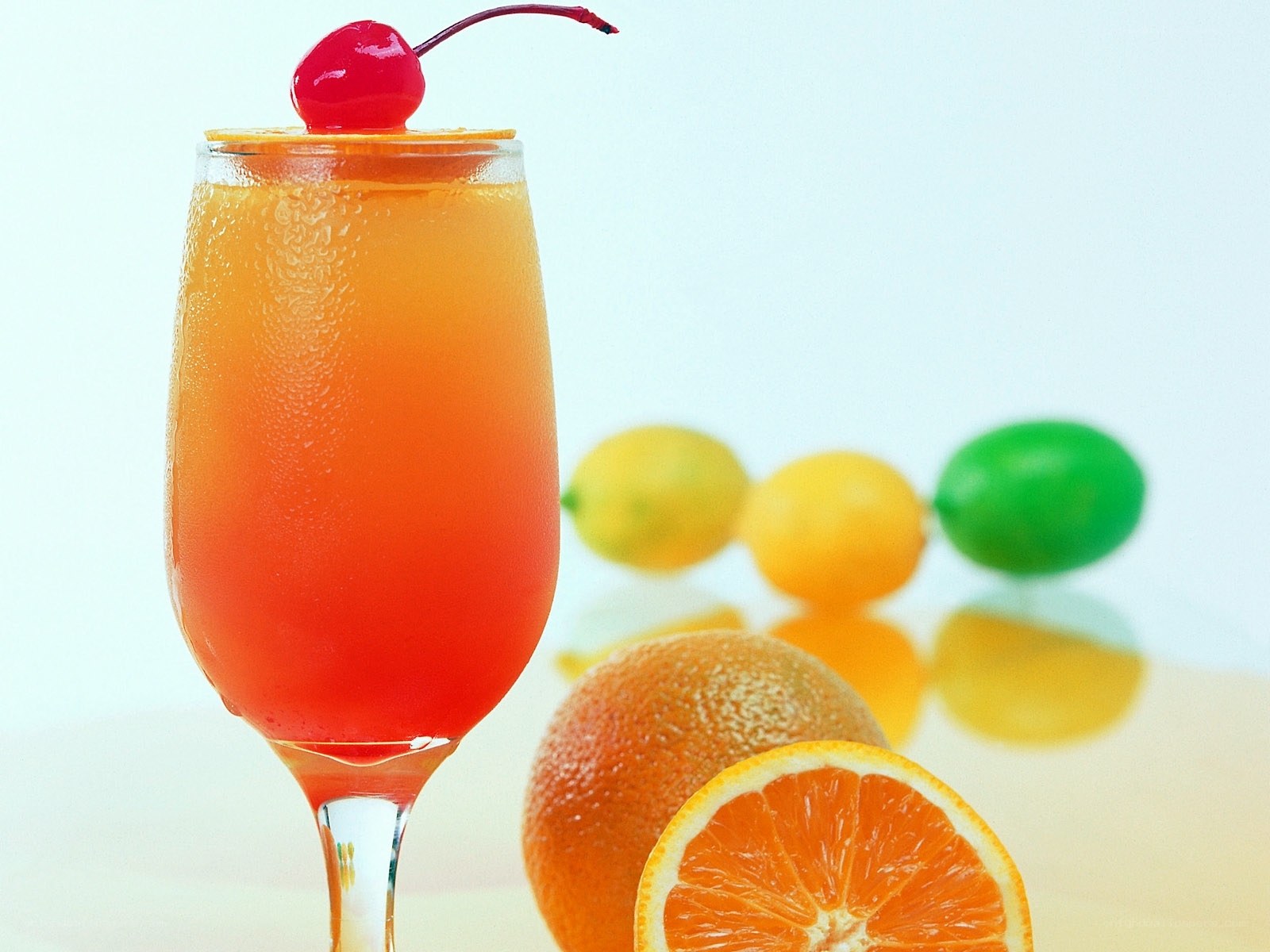 orange cocktail with cherry