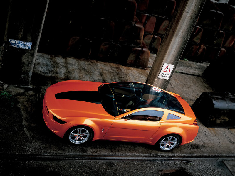 Orange Concept Car — Dramatic, Photograph, Concrete Wall