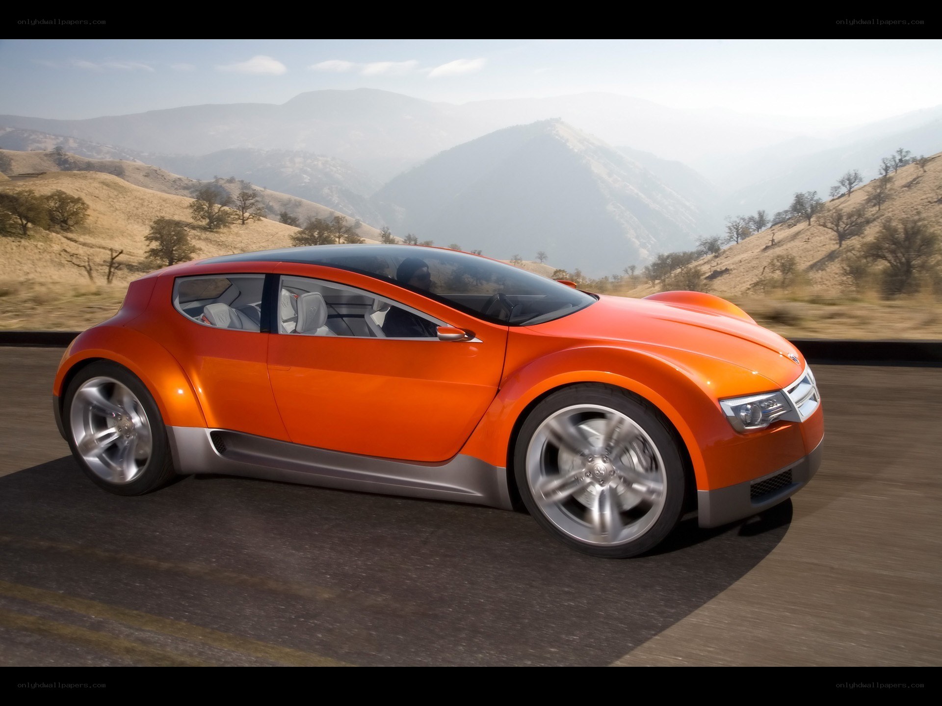 Orange concept car on mountain road