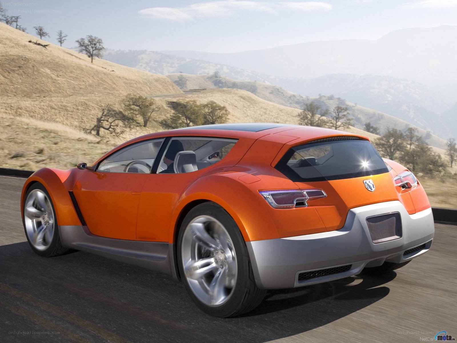 orange concept car on road